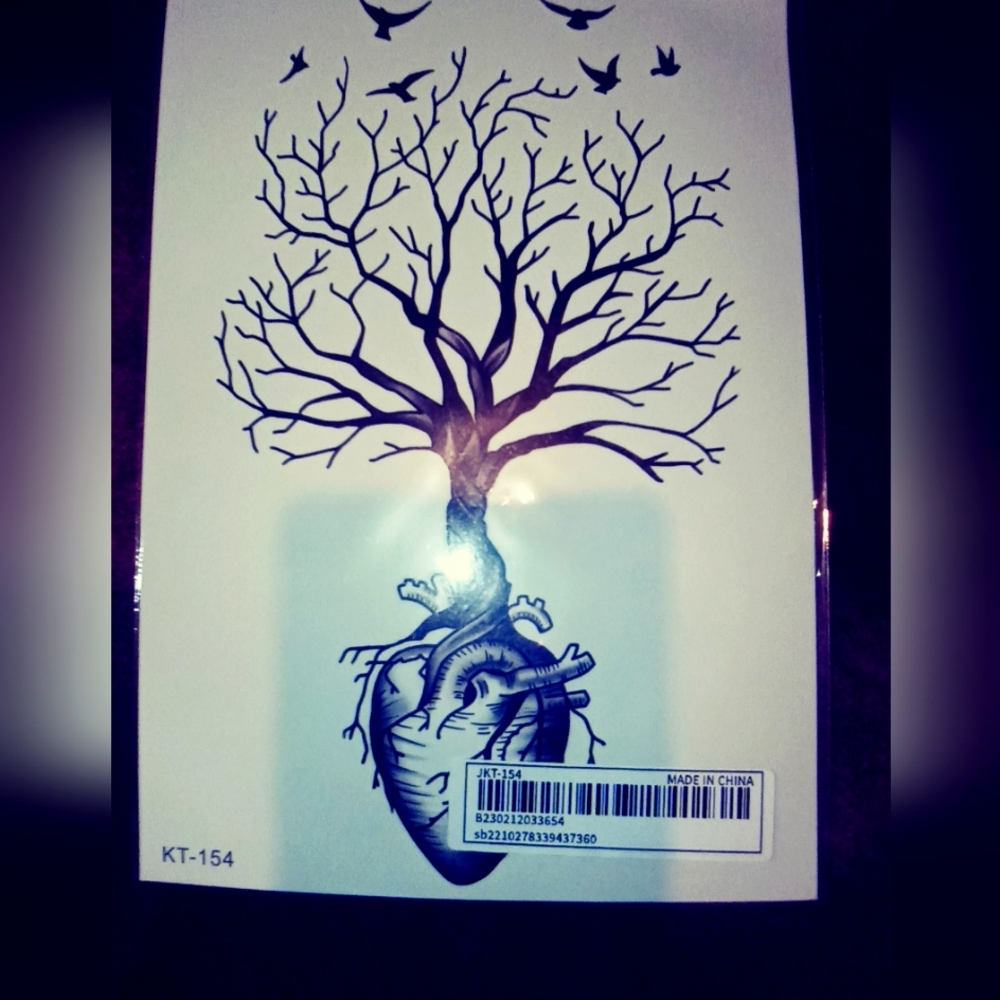 Tree of life with crows wrapped around heart tattoo